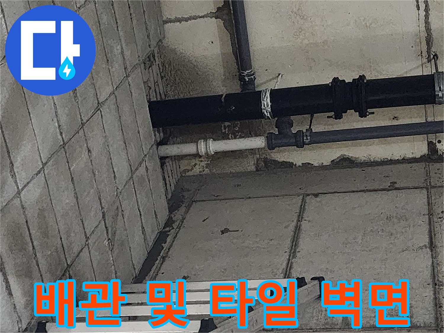 싱크대 아래쪽 배관과 타일로 이루어진 현장 모습