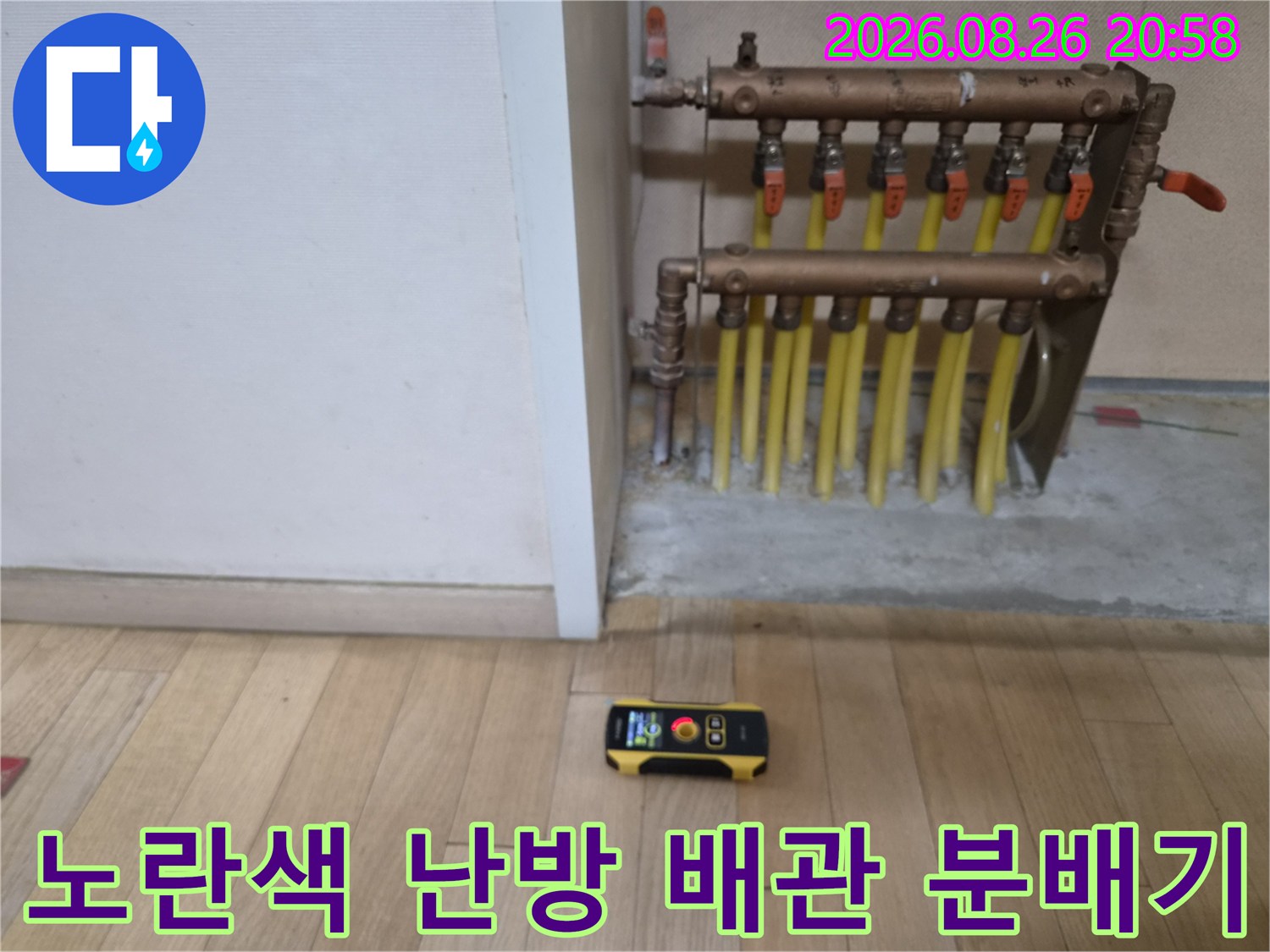 벽면에 설치된 금속제 분배기와 연결된 노란색 배관의 상세 모습입니다.
