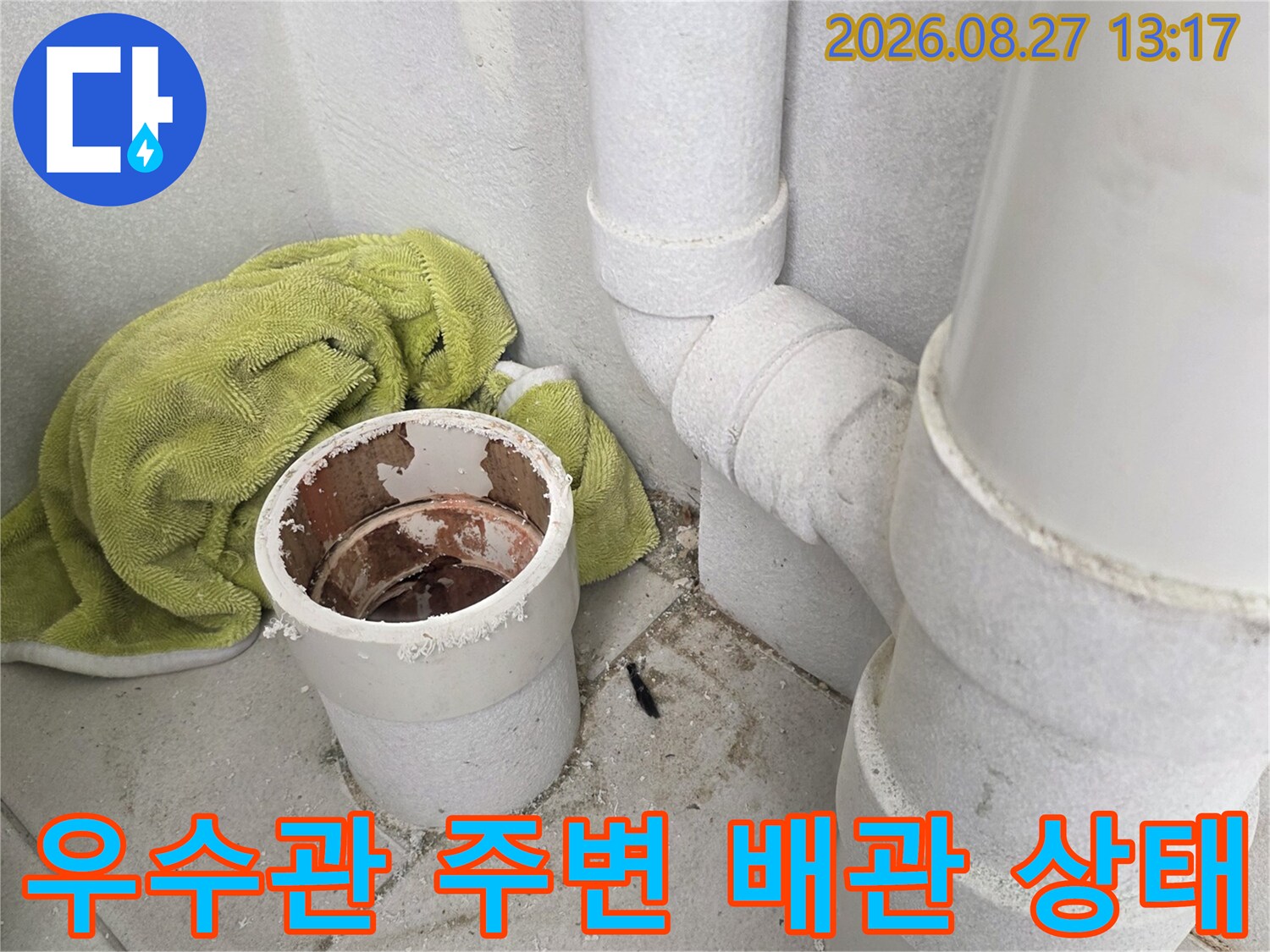 분리된 우수관 끝부분과 상단에 연결된 수직 배관의 구조를 보여주는 사진입니다.