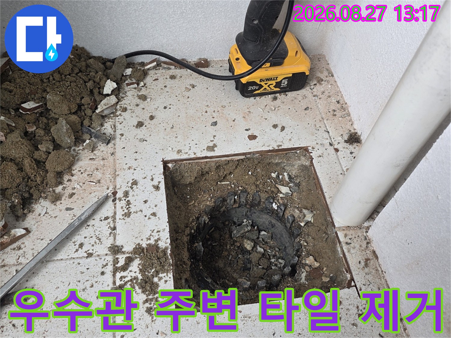 파쇄된 바닥면 - 우수관 배관 주변의 흙과 파손된 타일 조각들