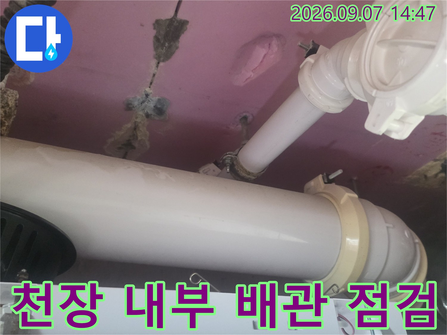화장실 천장-습기로 인해 얼룩진 마감재와 노출된 배관 연결 부위