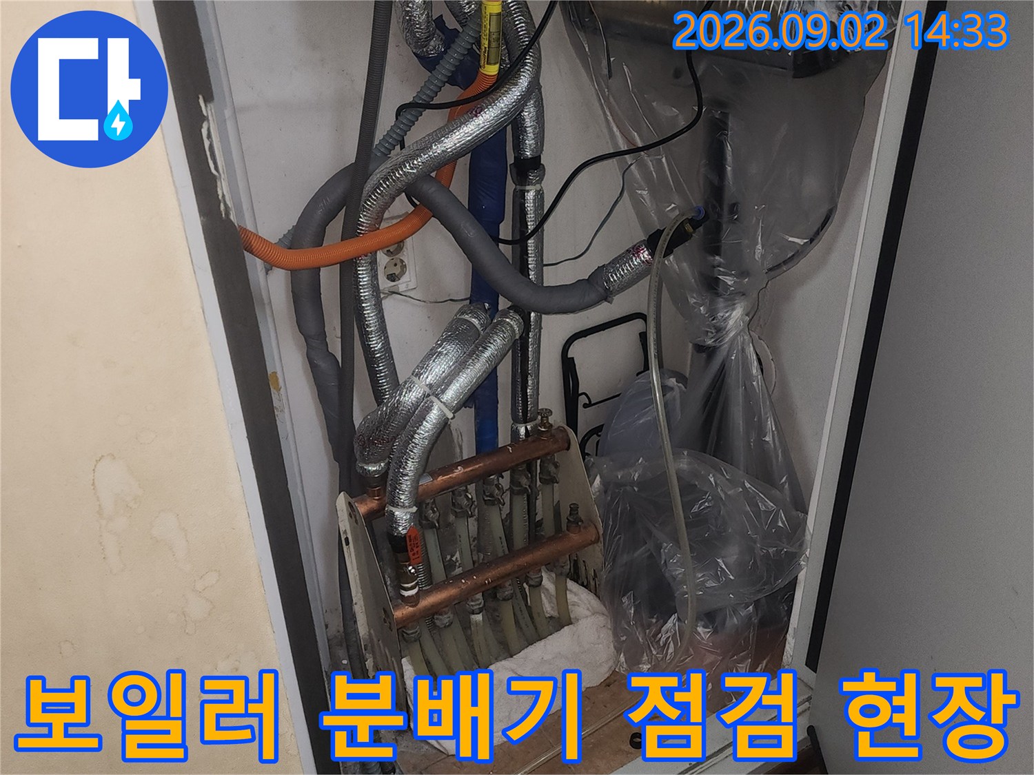 보일러실 내부에 설치된 분배기와 은색 보온재로 덮인 배관들