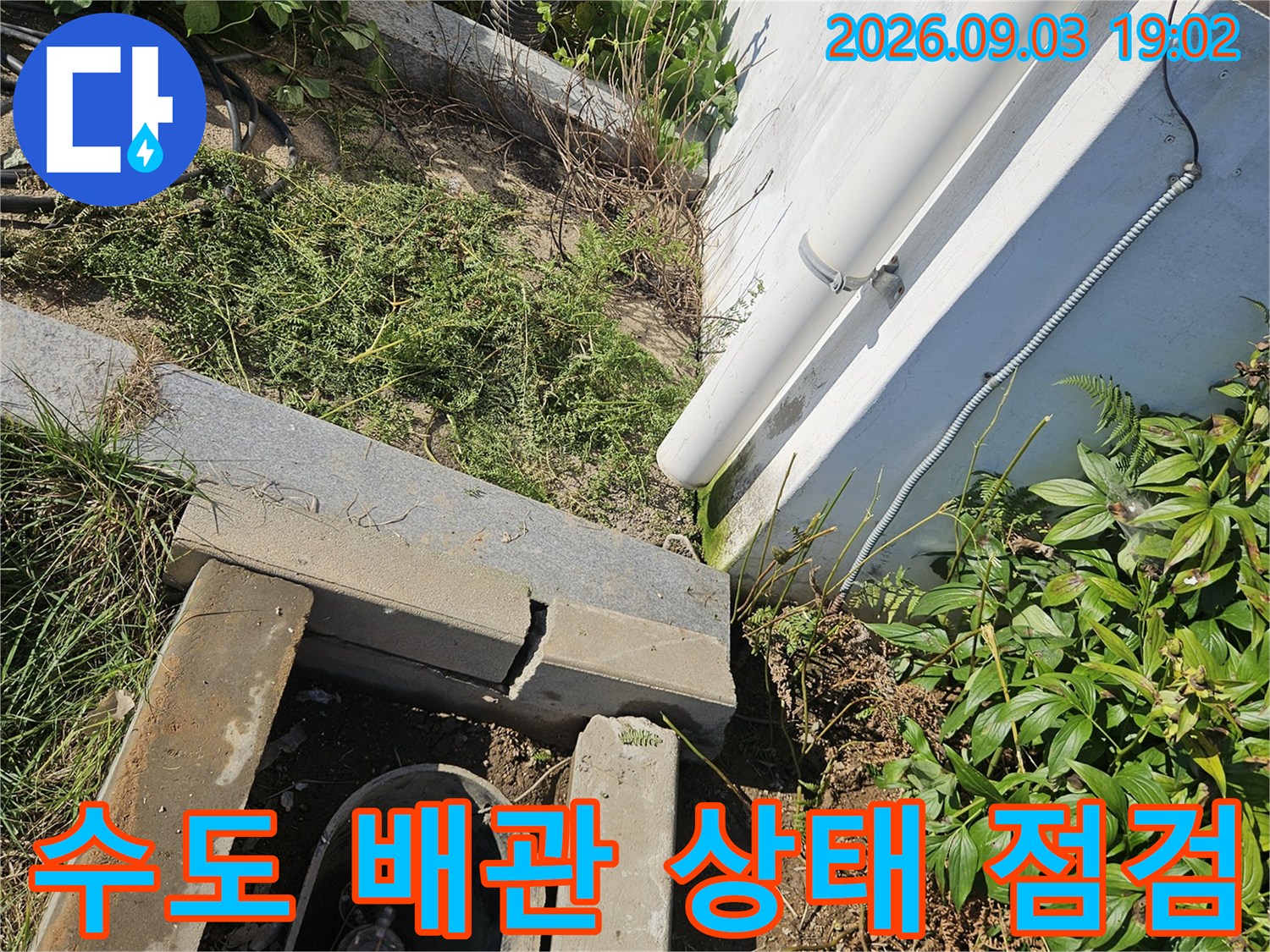 수도 계량기함-흙 속에 매립된 배관의 연결 부위를 집중적으로 관찰하는 장면