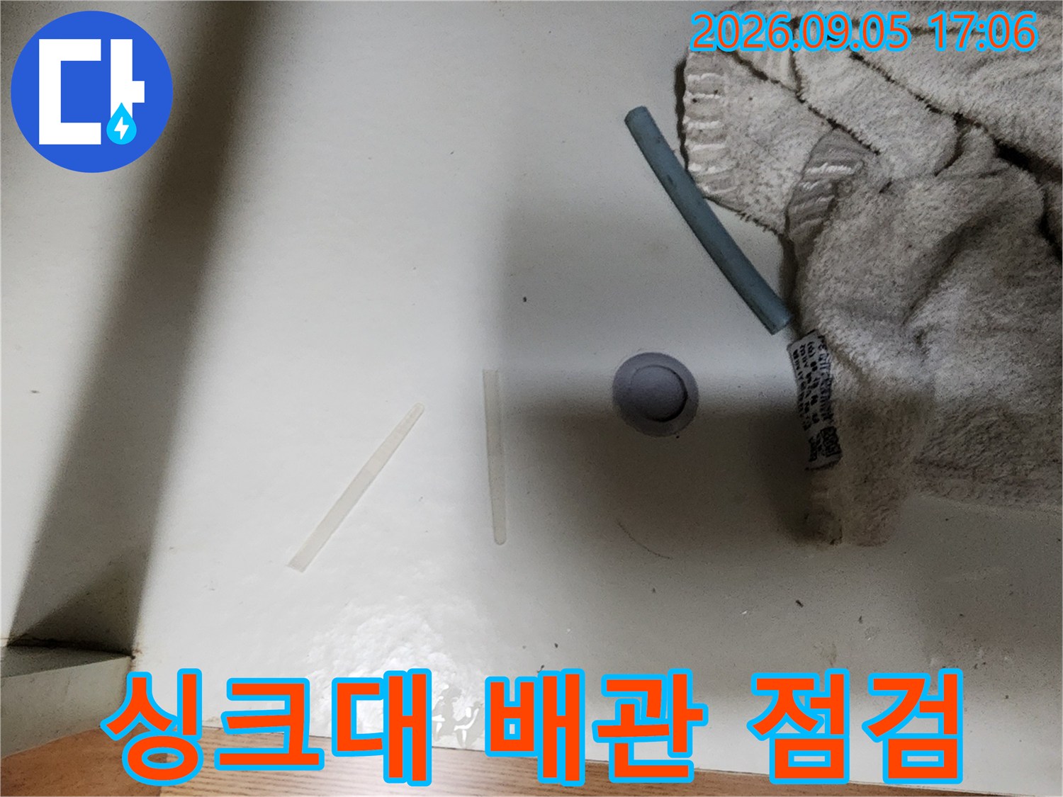 성남동 싱크대 하부 배관의 연결 부위를 확인하는 모습입니다.