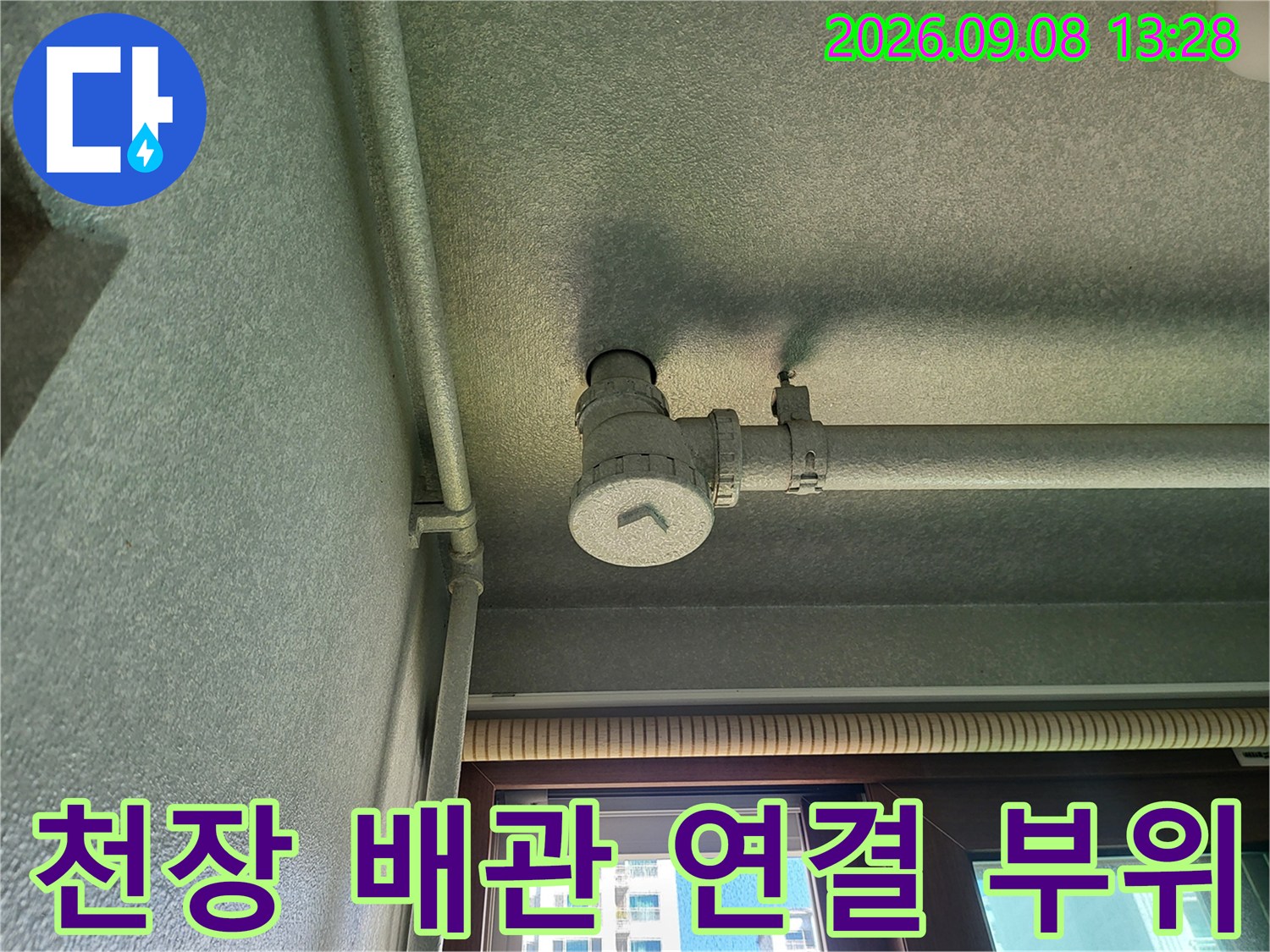 세탁실 천장 끝부분에 위치한-배관의 굴곡진 연결 부위를 상세히 보여줍니다.