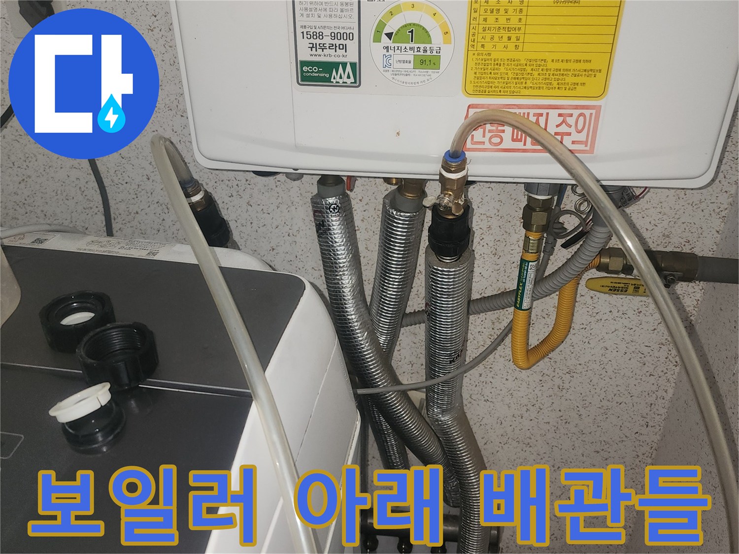 보일러 기기 하단에 설치된 금속 및 고무 재질의 배관 라인