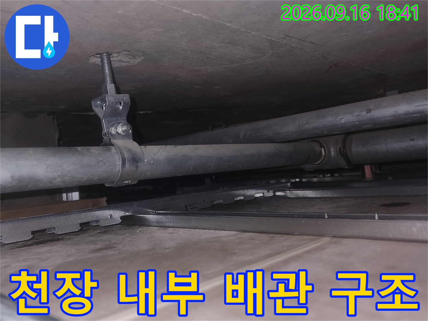 천장 속에 설치된 수직 배관과 고정 부품